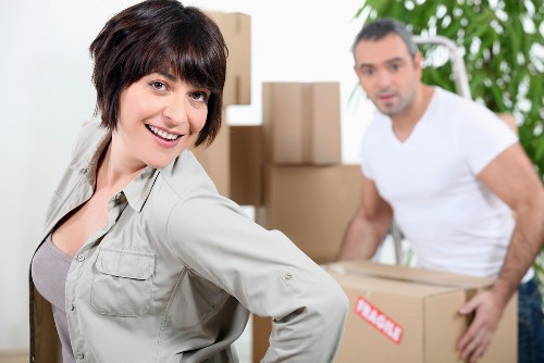 Professional movers handling office equipment carefully
